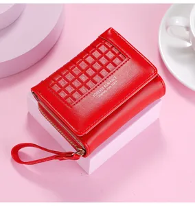 Close-up detail of red short women's wallet, compact trifold design with card slots and zipper pocket.