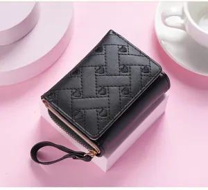 Black short wallet with embroidered hearts, compact trifold design, ideal accessory for daily use.