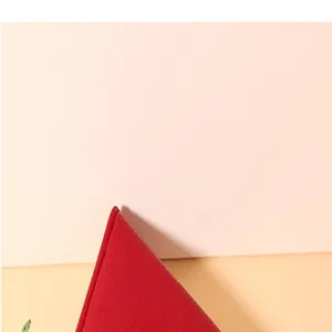 Red leather wallet detail closeup showing fine texture, precise stitching and vibrant color.