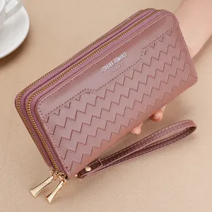 Close-up of a women's double zipper long wallet with chevron pattern and wrist strap.