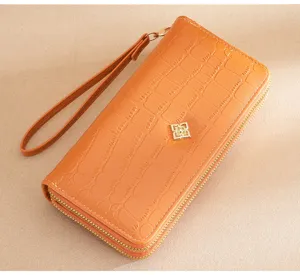 Orange women's long wallet with double zipper and wrist strap, stylish crocodile pattern design.