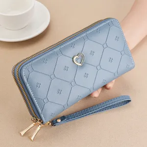 Women long double zipper wallet with embossed pattern and metal heart charm for use.