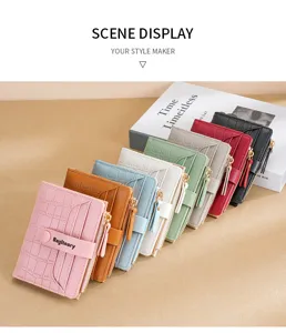 Stylish women's short wallet with multiple card slots, zip pocket, and crocodile design.