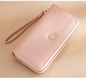 Pink crocodile pattern PU leather long wallet detail with dual gold zipper and wrist strap.
