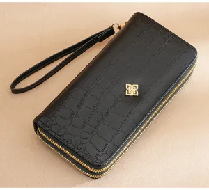 Women's long double zipper wallet with wrist strap, black faux croc leather clutch bag detail view.