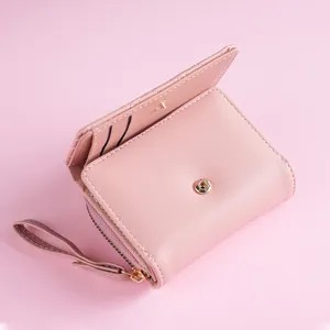 Women short pink wallet with wrist strap snap button and zipper coin pocket front view