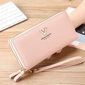 Pink long wallet detail view featuring pebbled PU leather, dual zippers and wrist strap.