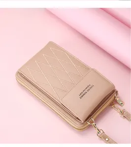 Detail view of pink crossbody phone bag, diamond stitching, metal chain and front pocket.
