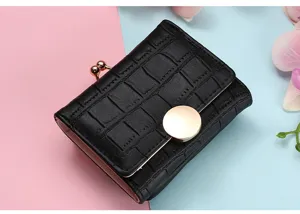Detail view of a black short foldable wallet with elegant crocodile pattern and gold clasp.