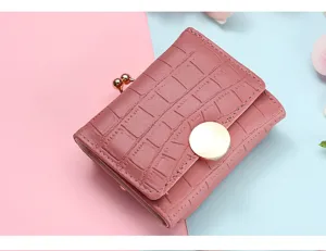 Pink short wallet with crocodile embossed texture, metal clasp closure and chic round button.