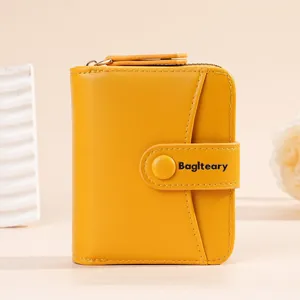 Compact yellow short wallet for women featuring a secure snap button and multiple card slots.