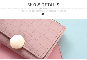 Close-up detail of pink crocodile pattern women short wallet with gold metal snap button.