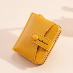 Yellow women short wallet detail, compact card holder with zipper and snap closure.