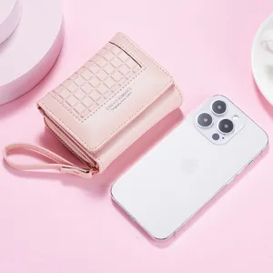 Detailed view of the compact pink short women's wallet with grid flap and handy wrist strap.