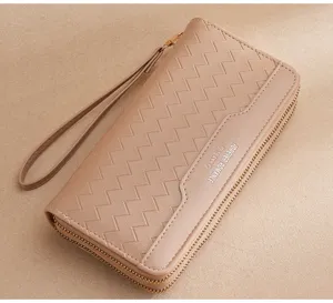 Detail view of women's long PU leather wallet with wrist strap and double zipper closure.
