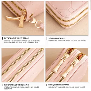 Pink long double zipper wallet with wrist strap and metal hardware detail design.