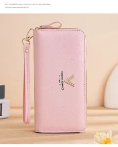 Detail view of women's pink long zip wallet, premium leather card holder and chic wrist strap.