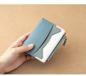 Detailed view of the compact color-block women's mini wallet showing zipper and card slots texture.