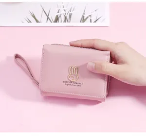 Roze korte portemonnee voor dames met drie vouwen, schattig konijn metalen bedel en handige polsband.