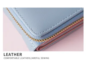 Nahaufnahme hellblauer Leder Kurzgeldbörse Reißverschluss Detail rosa Hintergrund Mode Accessoire