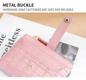 Pink leather bi-fold wallet for women with metal snap buckle, card slots and coin pocket.