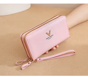 Detail shot of the pink double zipper long wallet wristlet, showing fine leather texture.