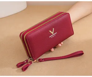 Women long double zipper leather wallet with wrist strap and metal V hardware decoration.