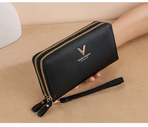 Detailed view of women's black long double zipper wallet with wrist strap and gold V logo.