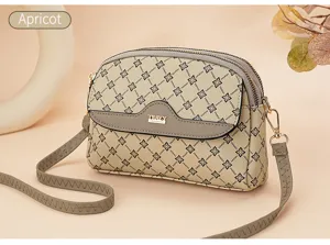 Detailed view of apricot vintage pattern double zipper crossbody bag with elegant design.