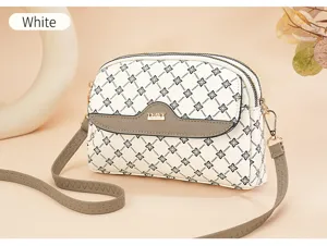 Detailed view of the white crossbody bag featuring elegant pattern and grey flap accent.