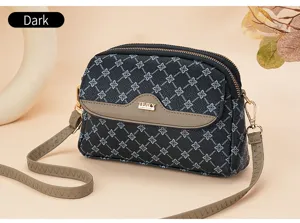 Women dark monogram crossbody bag stylish shoulder bag with double zipper and adjustable strap.