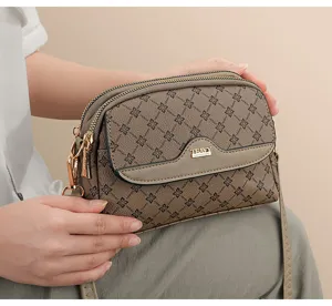Vintage monogram crossbody bag for women, stylish multi-compartment shoulder bag daily use.