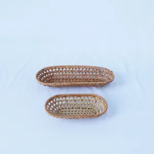 Woven rattan oval storage basket set of two, hollow fruit tray and tea towel holder for home.