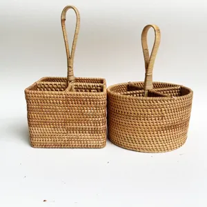 Close-up detail of woven rattan desktop storage baskets with handles for organizing small items.