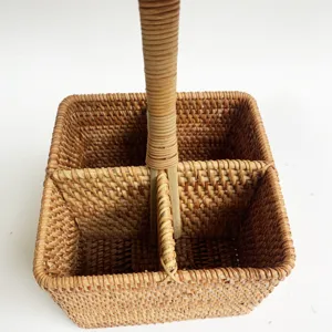 Detailed view of the 4-compartment woven rattan storage basket with a sturdy vertical handle.