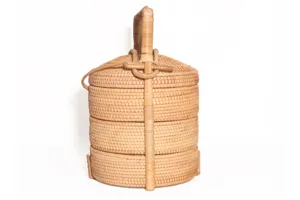 Close up of a 3 tier woven rattan tiffin box detail showing the exquisite handmade craftsmanship.