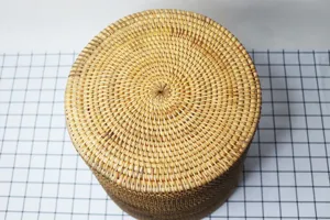 Close-up detail view of round woven rattan storage basket top texture and natural craftsmanship.