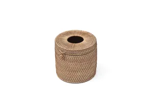 Detailed view of the handcrafted round rattan tissue box, showing neat weaving texture.