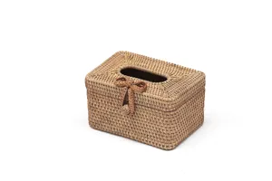 Detailed view of handmade woven rattan tissue box with bow, desktop organizer close-up.