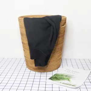 Woven rattan laundry basket with handles, ideal for home clothes storage and organization.