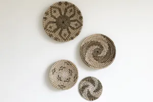 Detail view of natural seagrass woven wall hanging plates, boho decorative baskets for home.