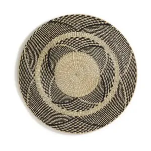 Close-up detail of hand-woven straw wall hanging showing natural texture and unique patterns.