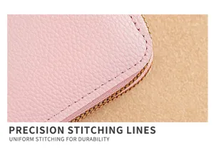 Close-up detail of pink textured leather wallet featuring neat precision stitching and zipper.