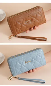 Close-up detail of women's long quilted PU leather wallet with wrist strap and metal zipper.