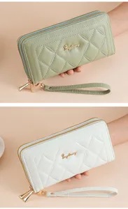 Detailed view of women long quilted wallet with double zippers and wrist strap for daily use.
