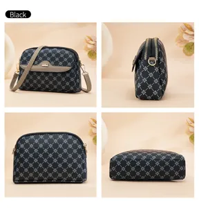 Detailed view of the black monogram crossbody bag, showing texture, zipper, and multi-angle design.