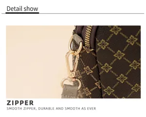 Crossbody bag detail showcase featuring durable smooth zipper and classic monogram pattern design.
