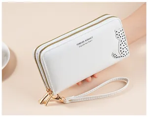 Close-up detail of white PU leather long wallet with cute cat pattern and double zipper design.