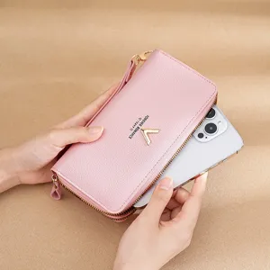 Pink long wallet for women with zipper and wrist strap, multi-functional card holder and phone purse.