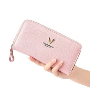 Pink long zip wallet for women with metal V logo, card slots and wrist strap for daily use.